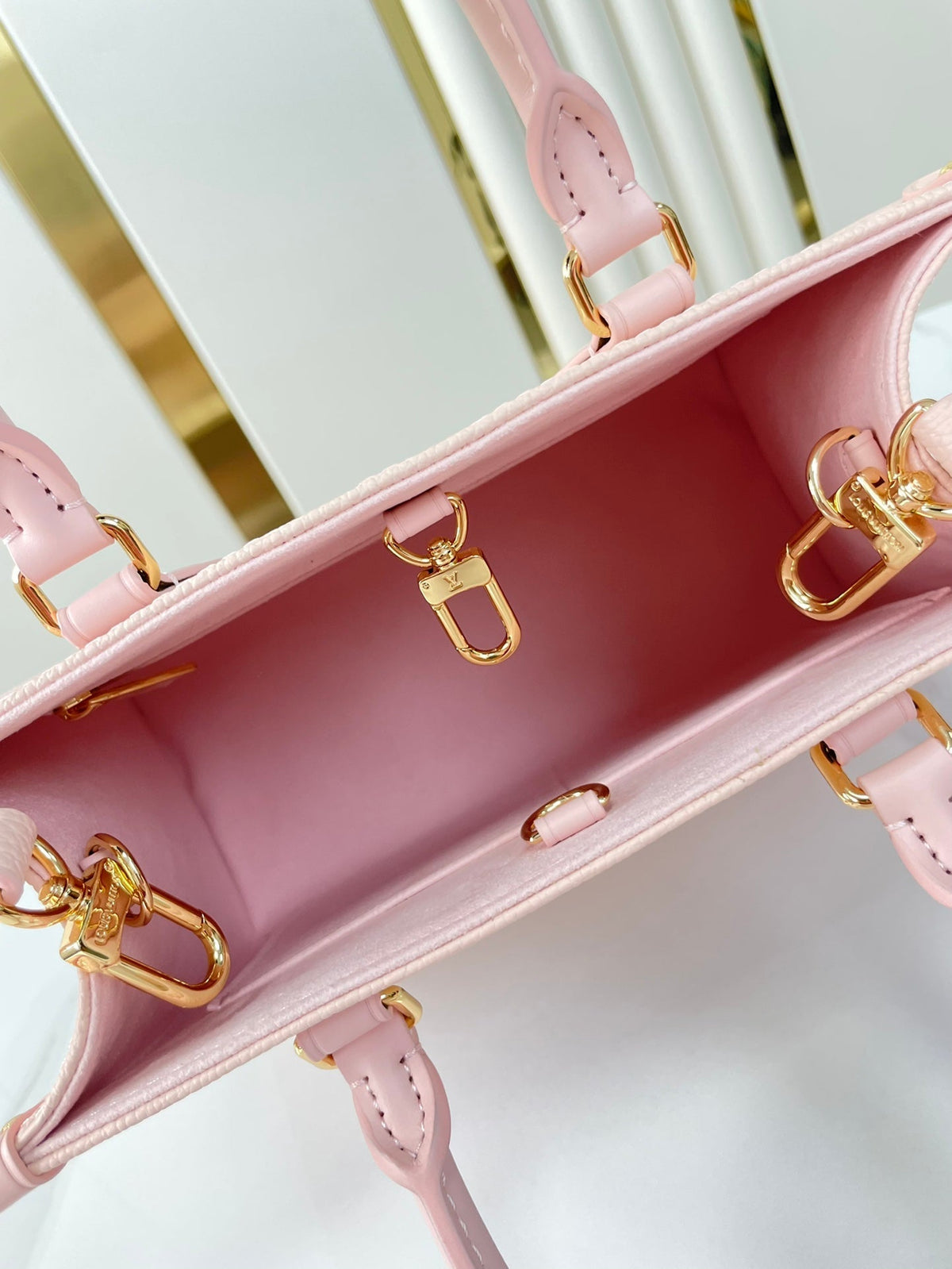 Onthego PM 25 in Opale Pink Monogram Empreinte Leather