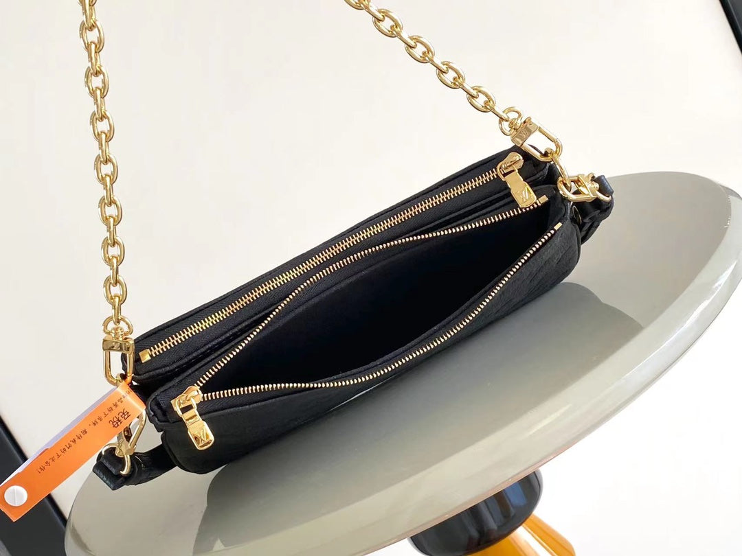 Liv Pochette 24 in Black Monogram Empreinte Leather Gold Hardware