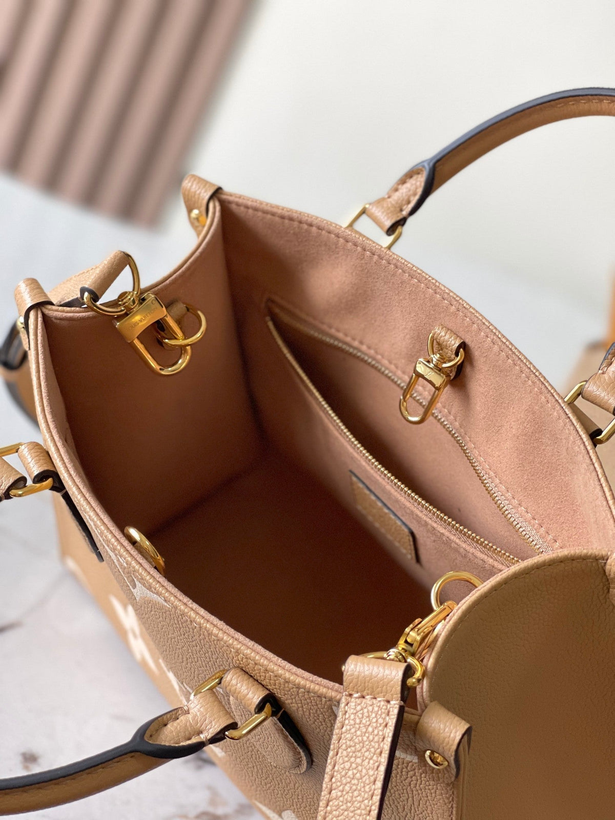 Onthego PM 25 in Milk Tea Monogram Impreinte Leather