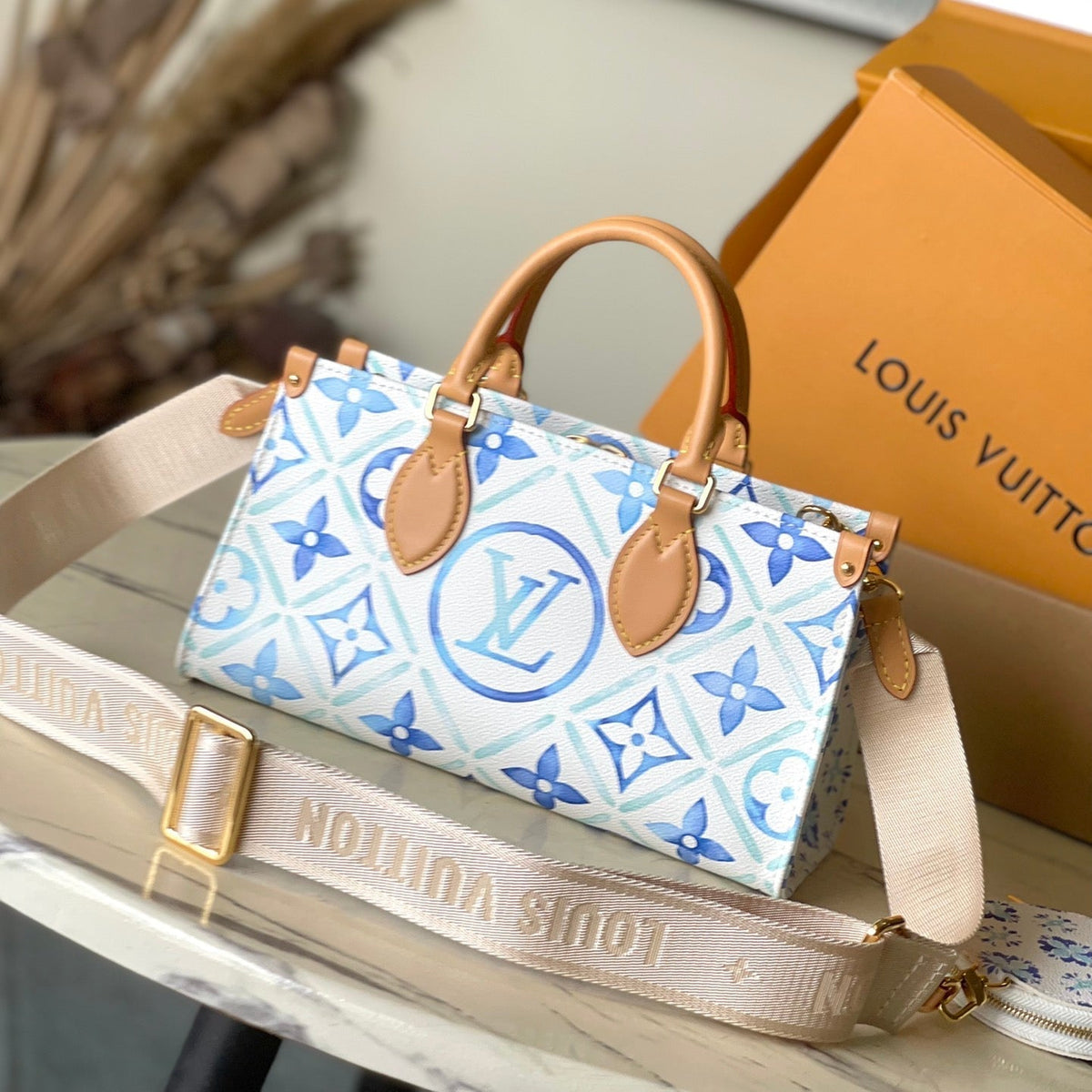 Onthego East West 25 in Lagoon Blue Monogram Tiles Canvas