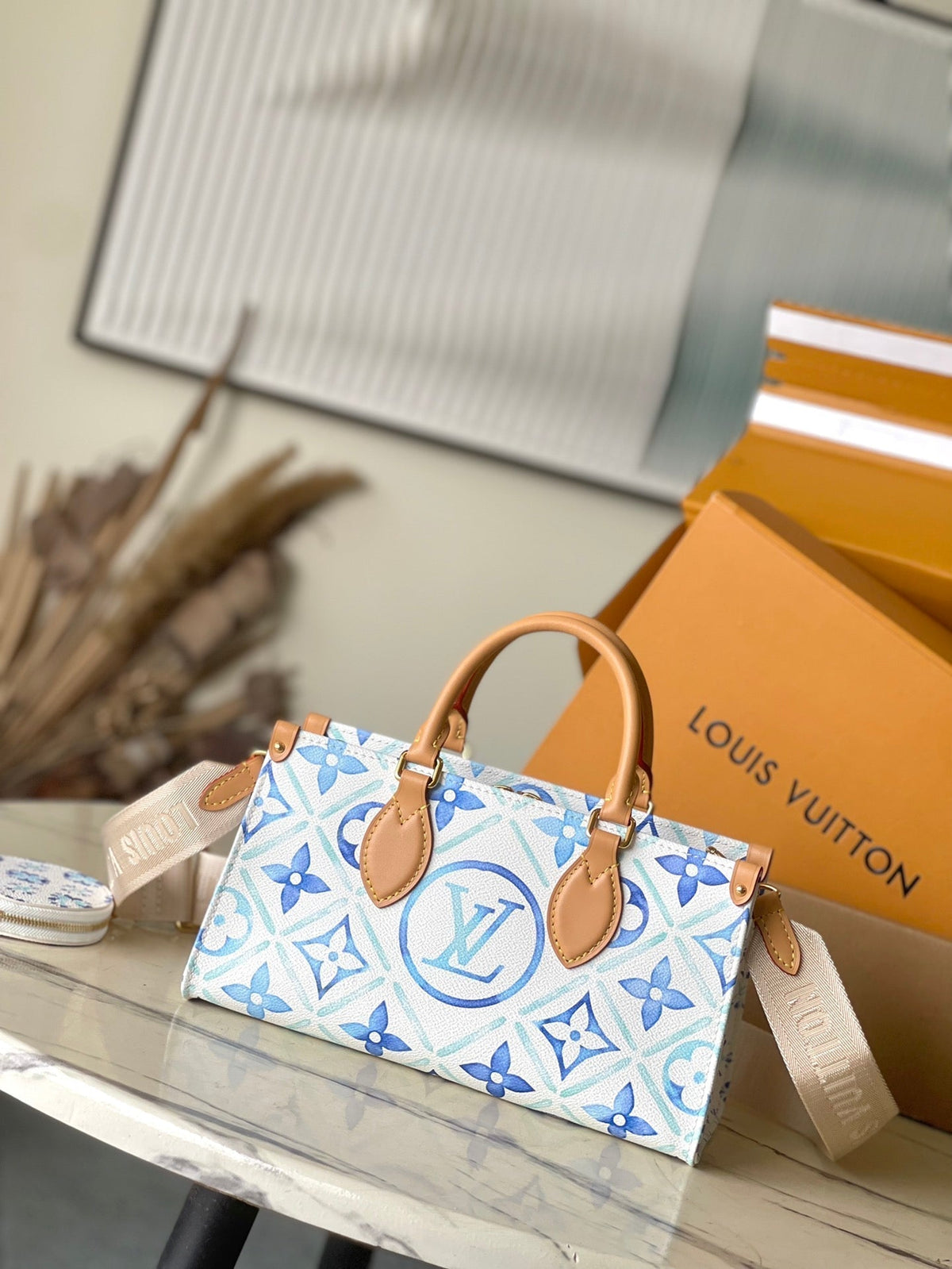 Onthego East West 25 in Lagoon Blue Monogram Tiles Canvas